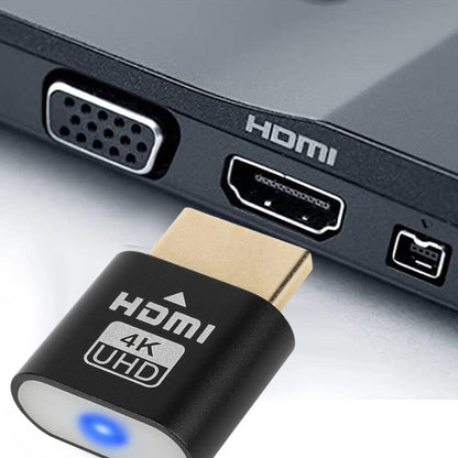 Black HDMI plug held just in front of a laptop's HDMI port, with VGA and mini ports beside it. 3