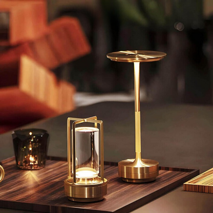 Gold-finish lamp glowing on a wooden tray beside a taller gold mushroom-shaped cordless table lamp. 7