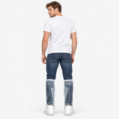 Back view of a man in a white t-shirt and jeans wearing clear overshoes over his trainers, looking over his shoulder. 4