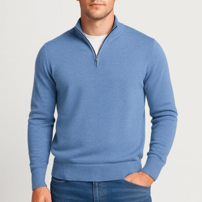Second view of the mid-blue quarter-zip jumper on a model, hand in pocket and a white T-shirt underneath. 13