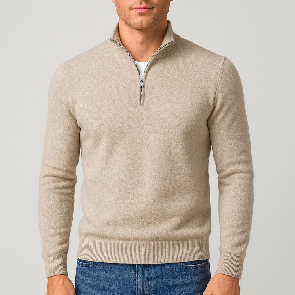Model wearing the knitted quarter-zip jumper in oatmeal beige with ribbed cuffs and hem, styled with blue jeans. 1