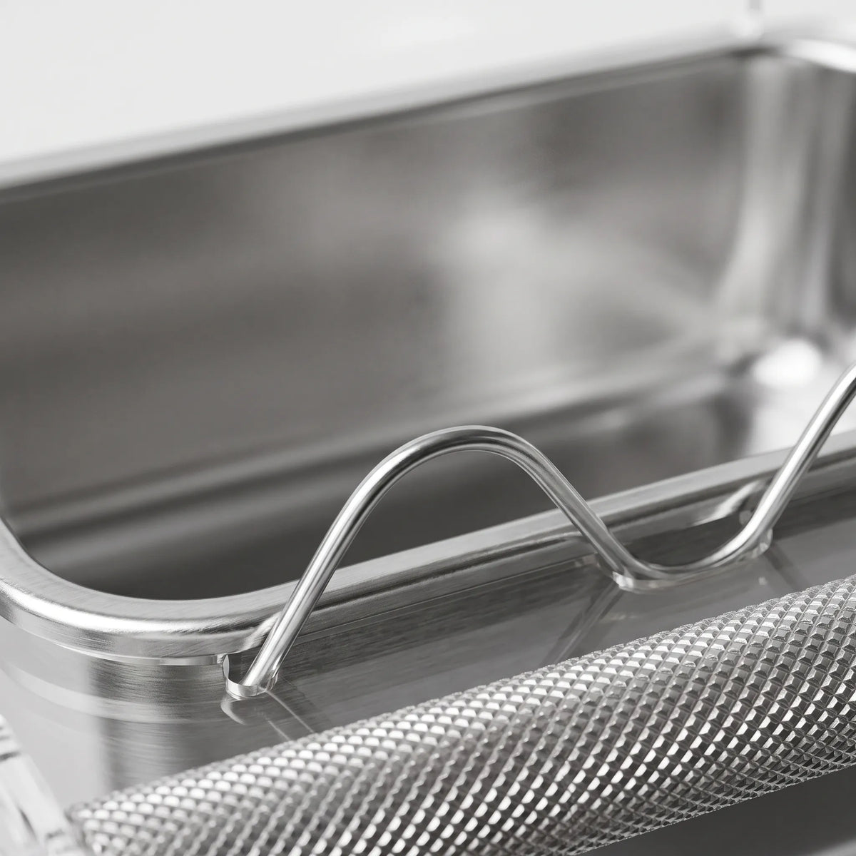 Close-up of the stainless steel tray, curved wavy clear divider and textured metal perch bar. 3
