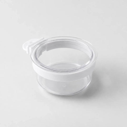 Empty clear round cup with a white band around the rim and a small white hook tab, shown on a plain light background. 1