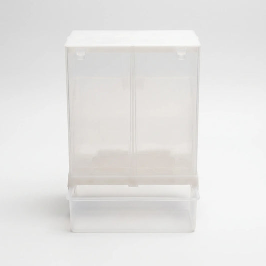Front view of the clear plastic seed dispenser with a white lid and an attached catch tray at the bottom. 1