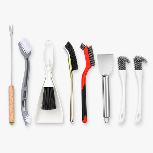 Flat lay of eight cage cleaning tools in a row: a fork, brushes, a dustpan set, a scraper and two small wire brushes. 1