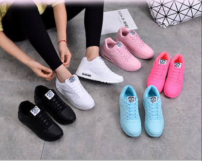 Flat lay of the trainers in black, white, pink, neon pink and light blue, one being laced 4