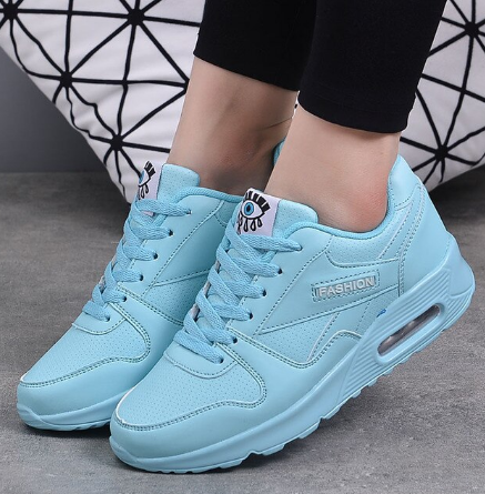 Light blue lace-up trainers with an air-cushion heel, worn with black leggings 8