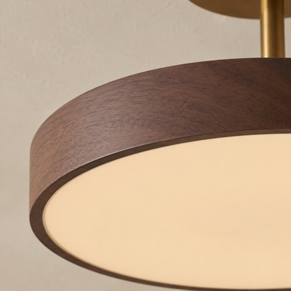 Close-up of the dark walnut-effect wood grain on the rim, with the brass-coloured stem and the frosted glowing diffuser beneath. 8