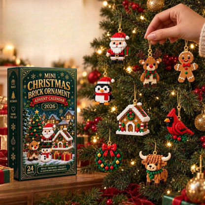 Hand hanging a brick Santa among reindeer, penguin, gingerbread house and cardinal ornaments on a lit tree, box beside it. 3