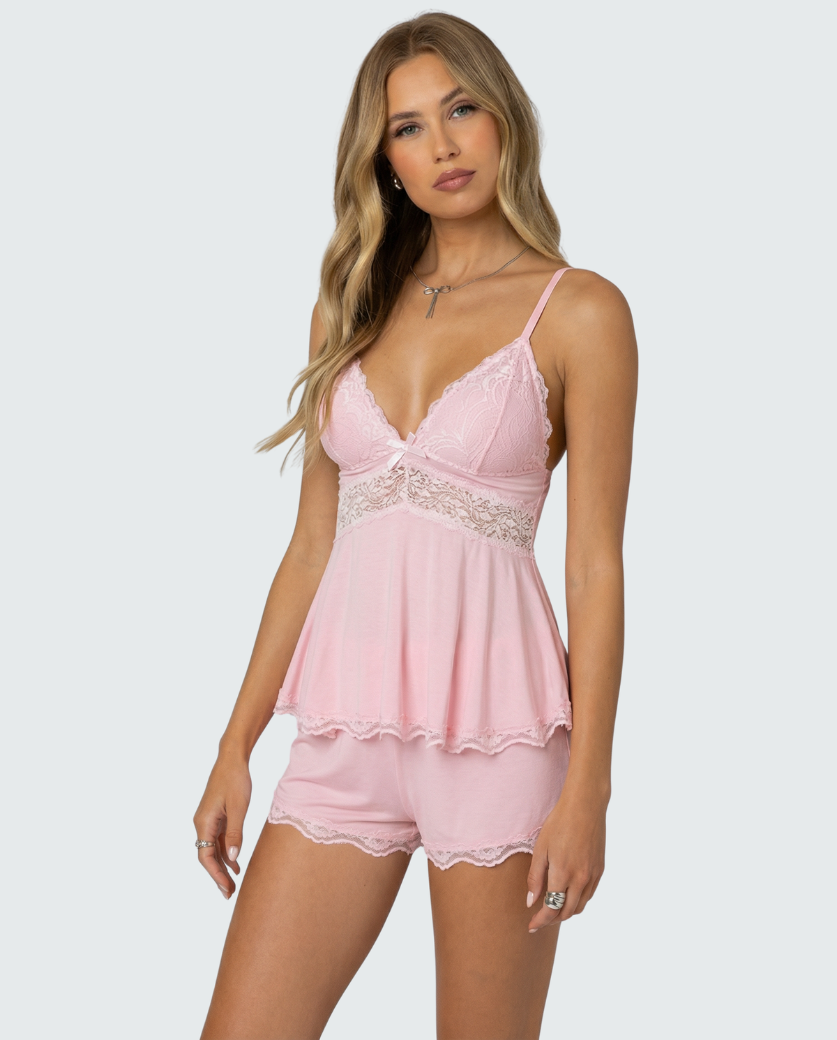 Model wearing the pink set in a three-quarter front view, showing the lace trim and bow 2