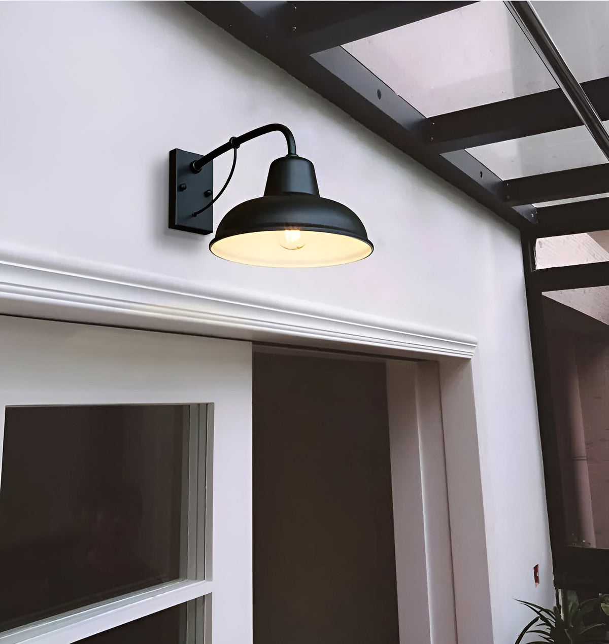 Black wall light switched on above a white door with moulded trim, under a glazed canopy with dark beams. 4