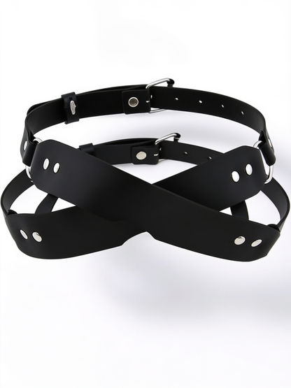 Black crossed-strap blindfold with silver rivets, D-rings and two adjustable buckled straps, shown flat on white 1