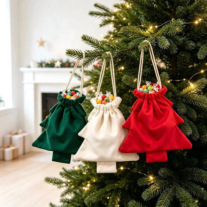 Green, cream and red velvety tree-shaped bags filled with sweets hang from a lit Christmas tree 1
