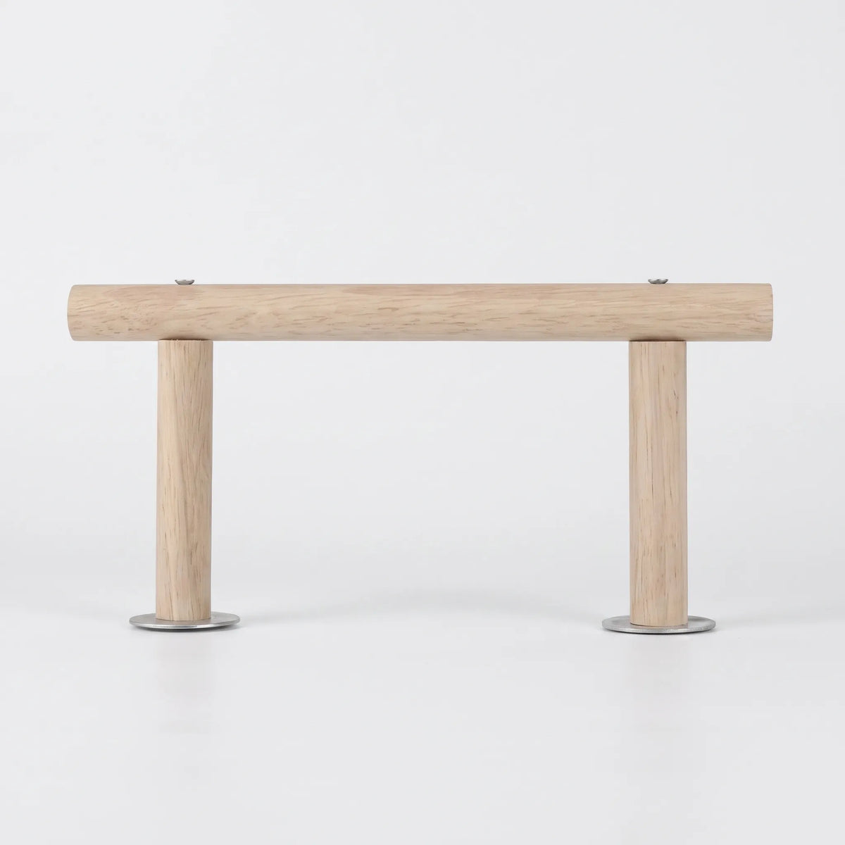 Side view of the light wooden perch on a plain white background, a horizontal bar held by two short legs with metal discs. 1
