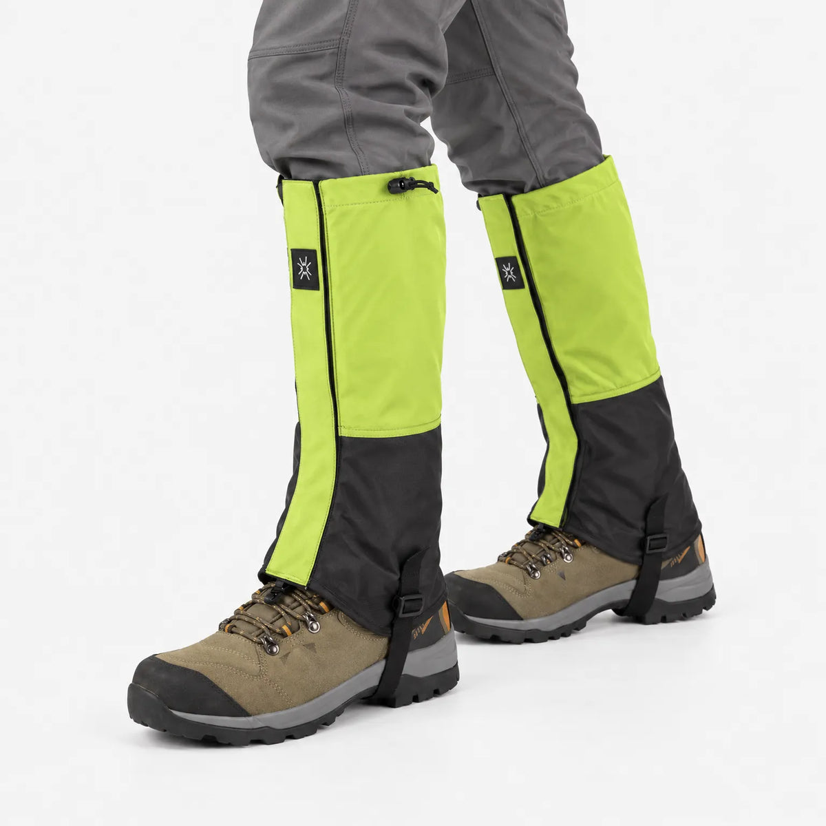 Lime green and black gaiters worn mid-stride over tan hiking boots, shown against a plain white background. 4