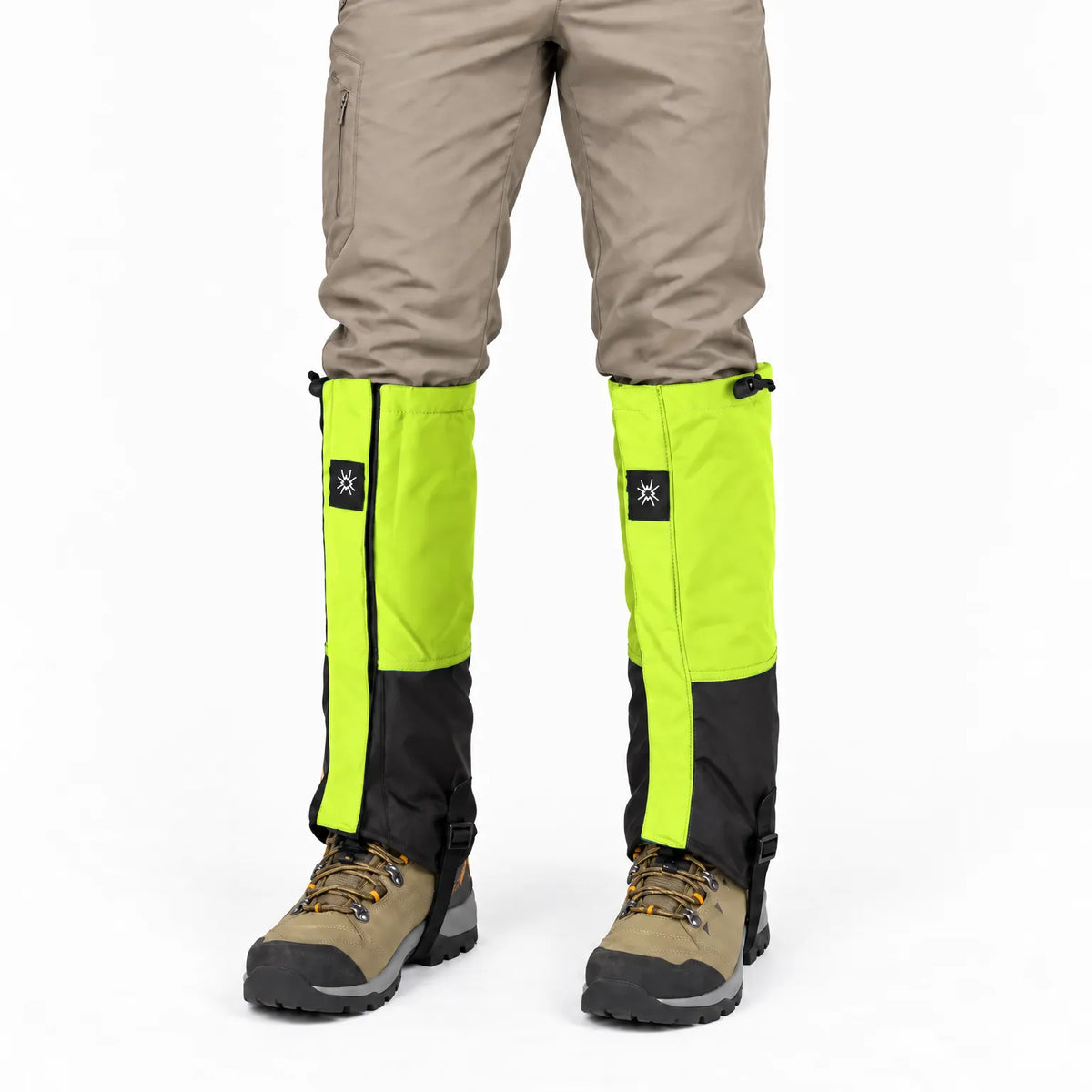 Front view of lime green and black gaiters worn with beige trousers and tan hiking boots, with drawcords at the top. 6
