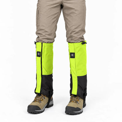 Front view of lime green and black gaiters worn with beige trousers and tan hiking boots, with drawcords at the top. 6