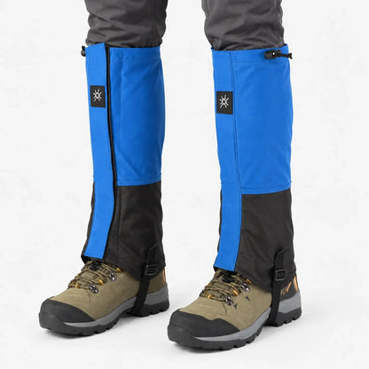 Front view of blue and black gaiters with drawcord tops and boot straps, worn over olive hiking boots and grey trousers. 7