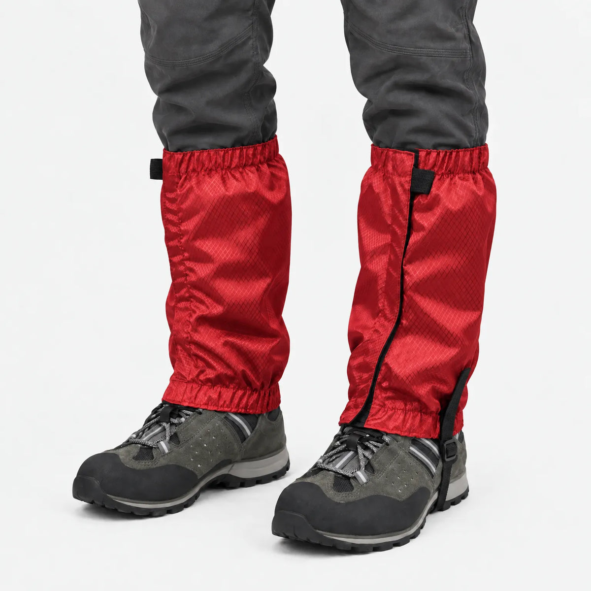 Red ripstop gaiters with elastic tops and hems, worn over grey hiking boots and dark trousers against a white background. 7