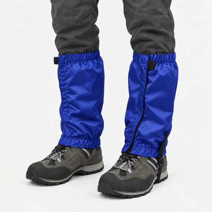 Bright blue ripstop gaiters with elastic tops and hems, worn over grey hiking boots and dark trousers against a white background. 8