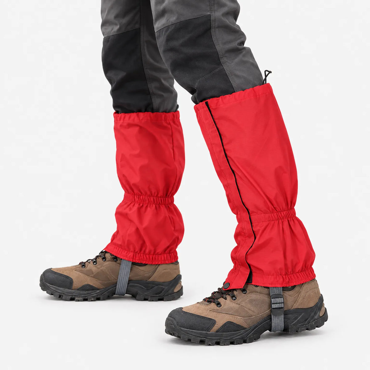 Close-up of red gaiters worn over hiking boots, showing the side zip, elasticated ankle, drawcord top and under-boot strap. 5