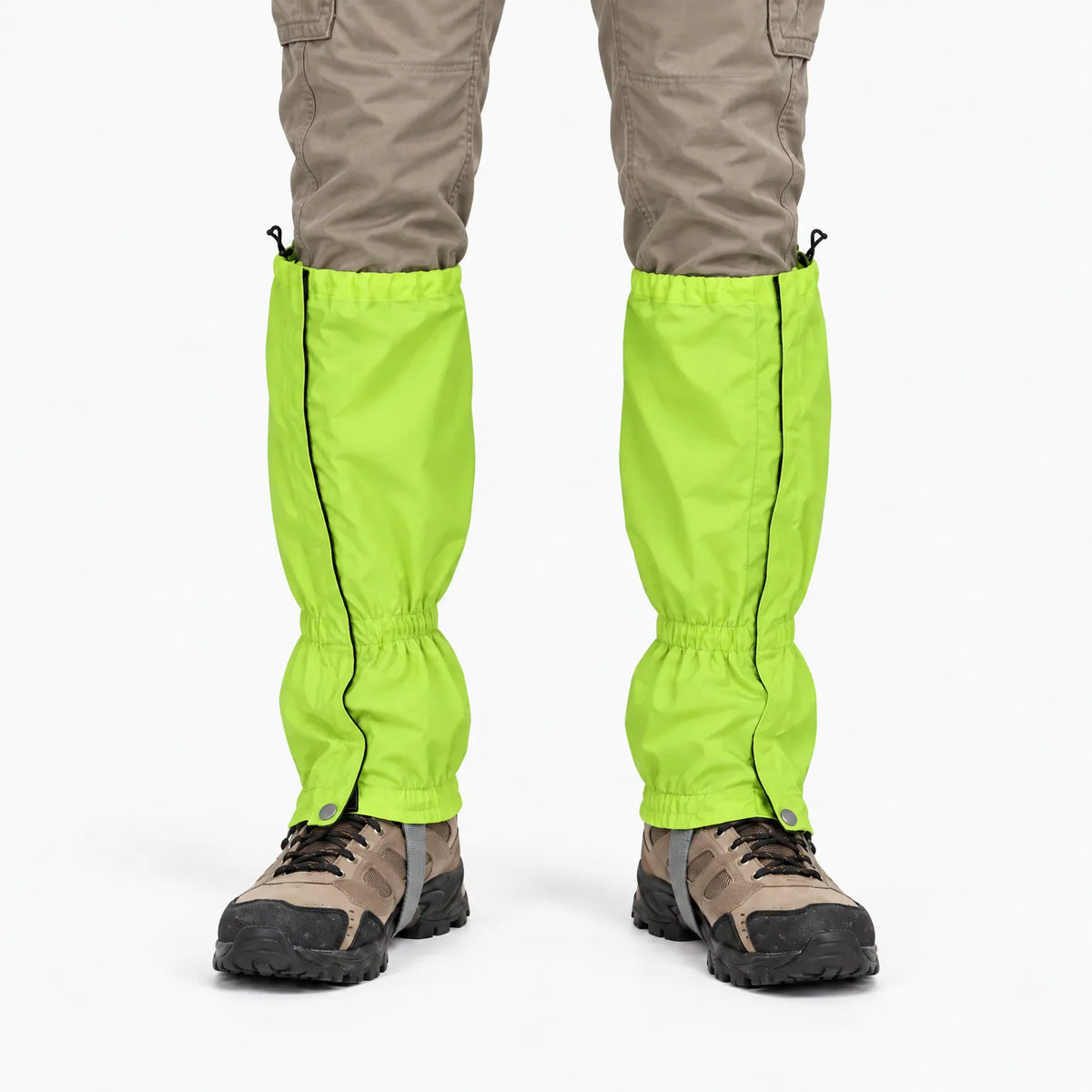 Front view of lime-green gaiters with black side zips, worn over beige trousers and brown walking boots against a white background. 7