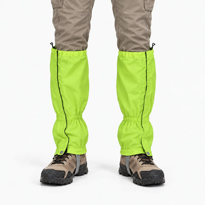 Front view of lime-green gaiters with black side zips, worn over beige trousers and brown walking boots against a white background. 7