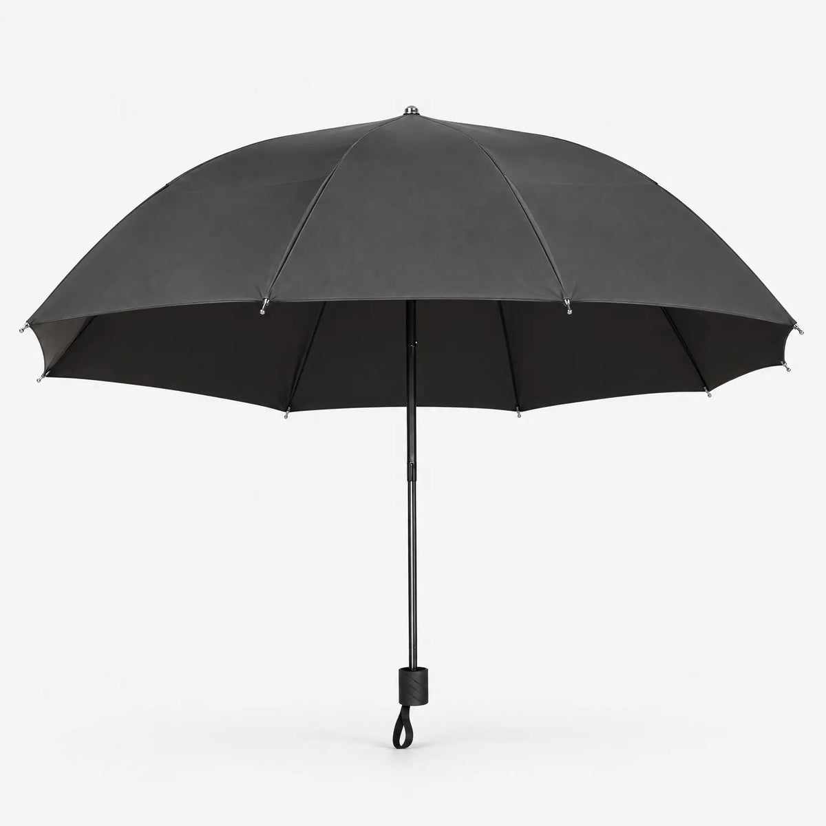 Open umbrella in dark grey on a white background, side view with the black canopy lining and wrist loop on the handle. 3