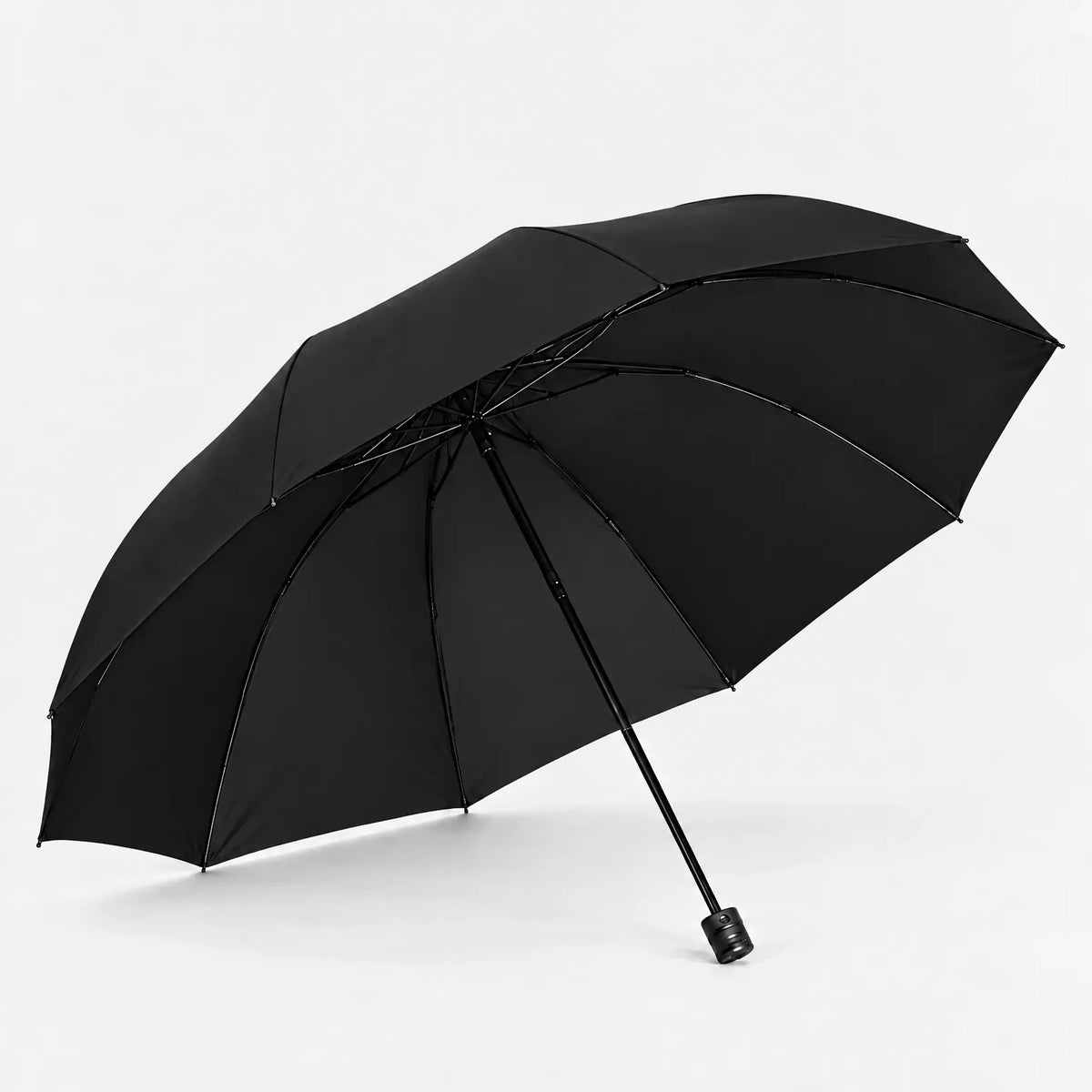 Open black umbrella seen from below at an angle, showing the ribs and plain handle against a white background. 5