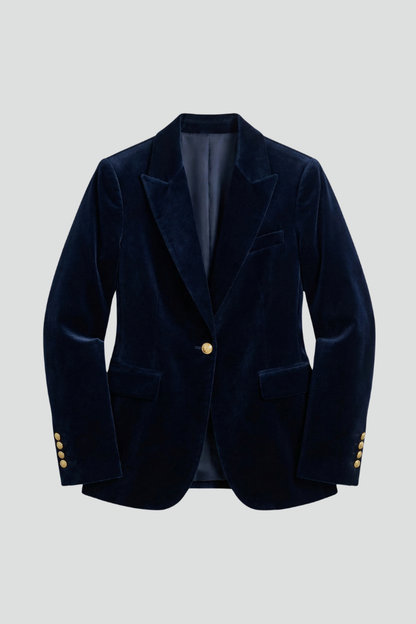 Navy velvet blazer laid flat, showing peak lapels, one gold button, flap pockets and buttoned cuffs 1