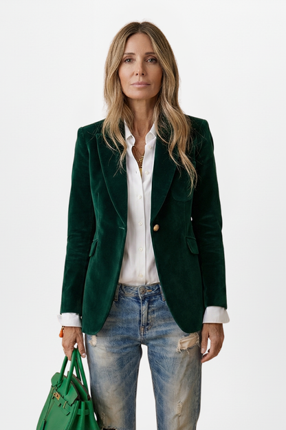 Model wearing the blazer in dark green velvet, with white shirt, ripped jeans and a green handbag 8