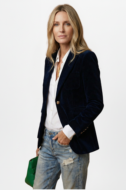 Model turned slightly to the side with one hand in her jeans pocket, wearing the navy blazer 3