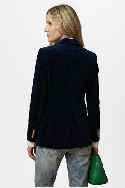 Back view of the navy velvet blazer on a model, showing the plain back and gold cuff buttons 4