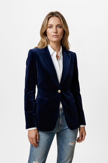 Model standing straight on in the navy velvet blazer, white shirt and light ripped jeans, arms relaxed 6