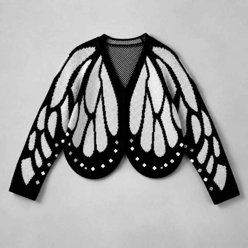 Flat lay of the cardigan in black and pale grey, with wing pattern and dotted scalloped hem 4