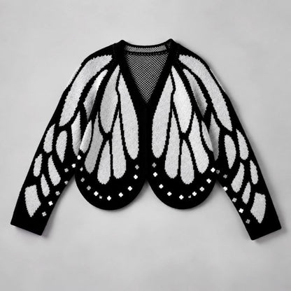 Flat lay of the cardigan in black and pale grey, with wing pattern and dotted scalloped hem 4