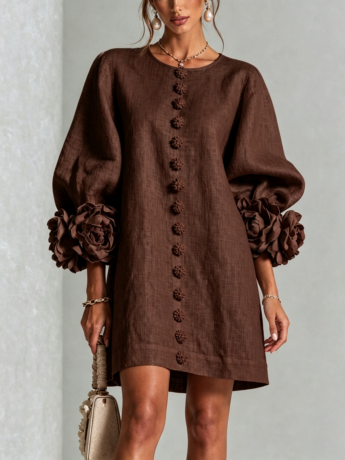 Close front view of the chocolate brown dress, showing floral buttons down the front and rose-trimmed puff sleeves. 27