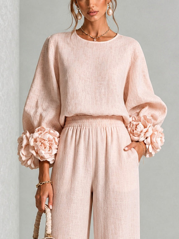 Close-up of the blush pink top, showing the round neckline, puffed sleeves and rose-style cuffs 8
