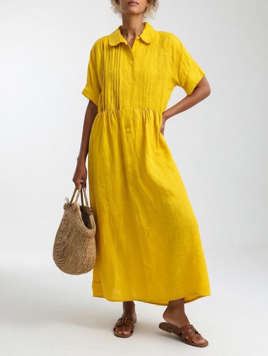 Model in the yellow dress with a hand on her hip, showing the softly creased fabric and flowing maxi skirt. 6