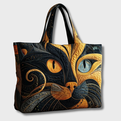Quilted cat-face tote seen at a slight angle against a plain pale background, showing its two handles 2