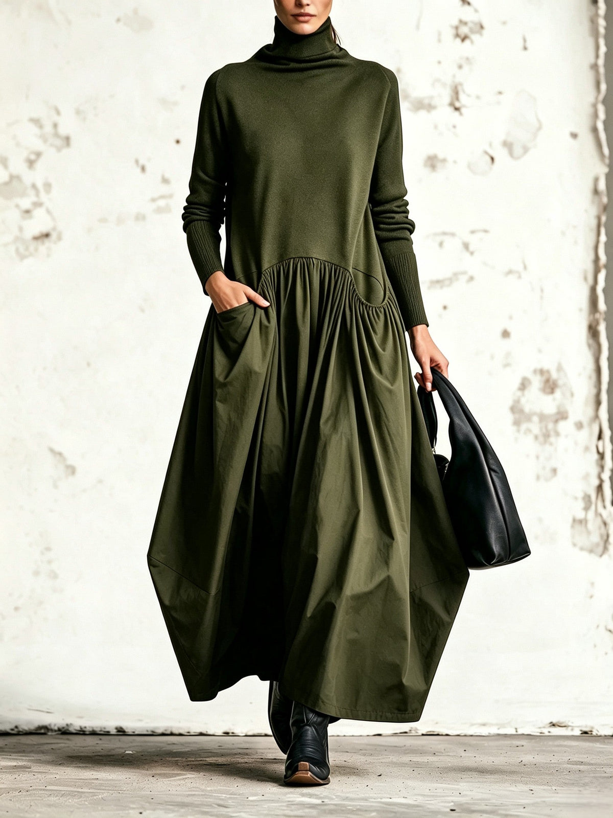 Front view of the dress in olive green with a knitted top, ribbed cuffs and pocket 4