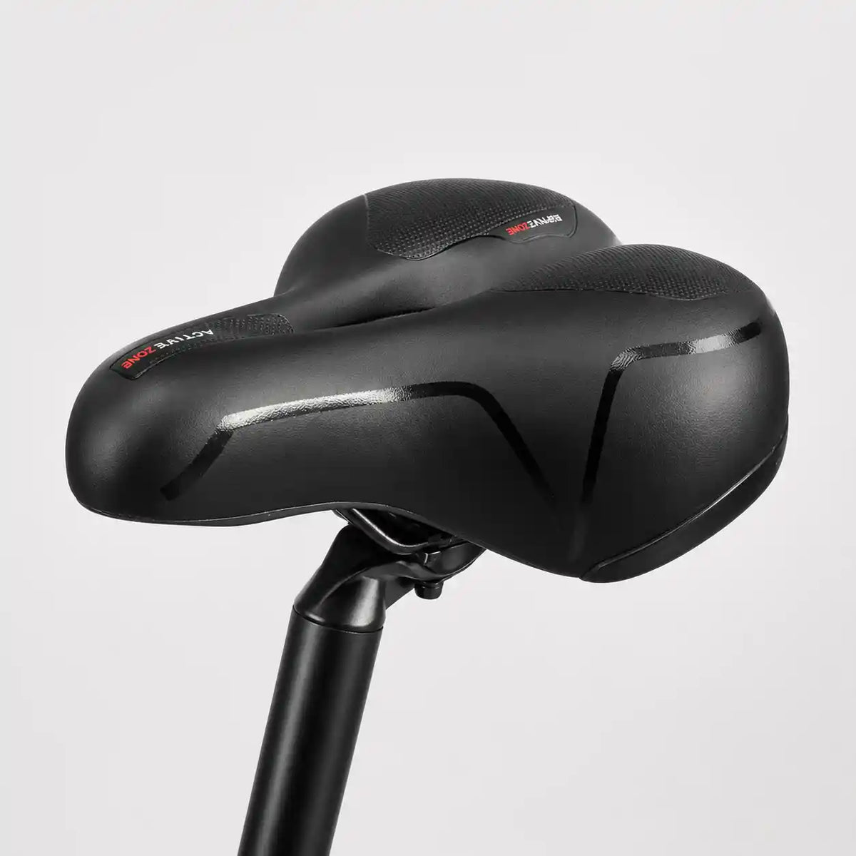 Side-on view of the black saddle mounted on a seat post against a plain grey background. 14