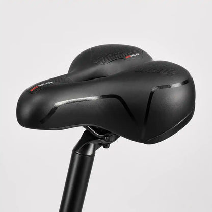 Side-on view of the black saddle mounted on a seat post against a plain grey background. 14