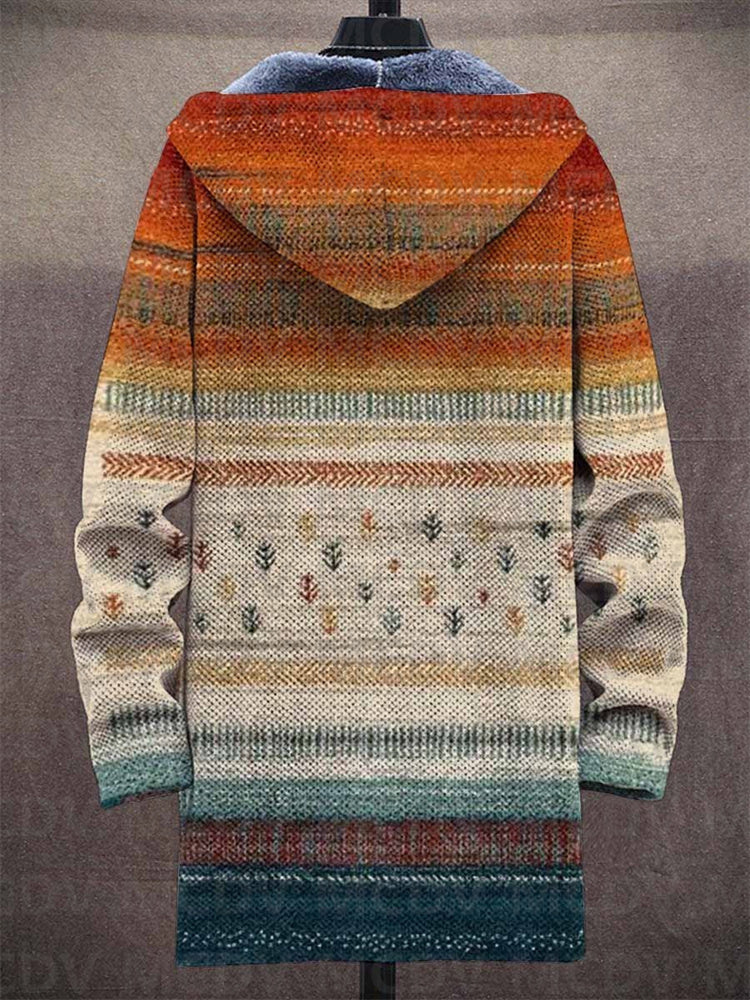 Back view of the long hooded cardigan on a mannequin, showing orange-to-teal striped knit pattern with small tree motifs 2