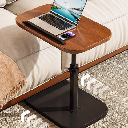 Walnut-effect desk beside a cream sofa with a laptop on top, and arrows on the floor showing it can be pushed along. 10