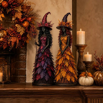 Purple and golden-orange witch figurines on a mantelpiece with pillar candles, small pumpkins and an autumn wreath behind them. 5