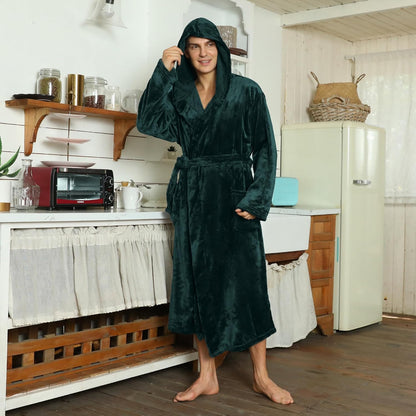 Model in the dark green hooded plush robe, hood up and belt tied, standing in a rustic kitchen 4