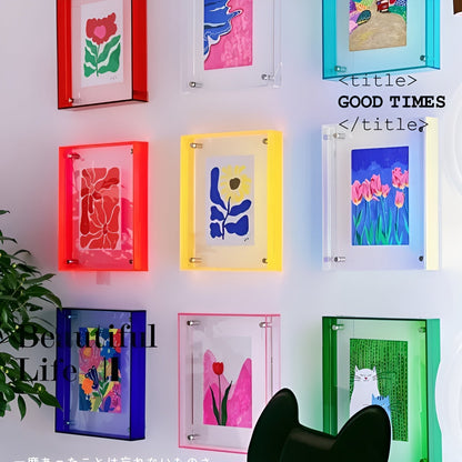 Wall display of red, yellow, blue, green, turquoise and pink acrylic frames holding floral and animal prints beside a plant. 3
