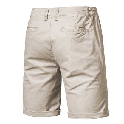 Back view of beige shorts showing two welted back pockets, belt loops and an elasticated waist at the sides. 2