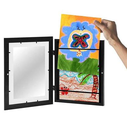 Black frame opened out as a hand slides a painted butterfly artwork in, with a second picture stacked below. 7